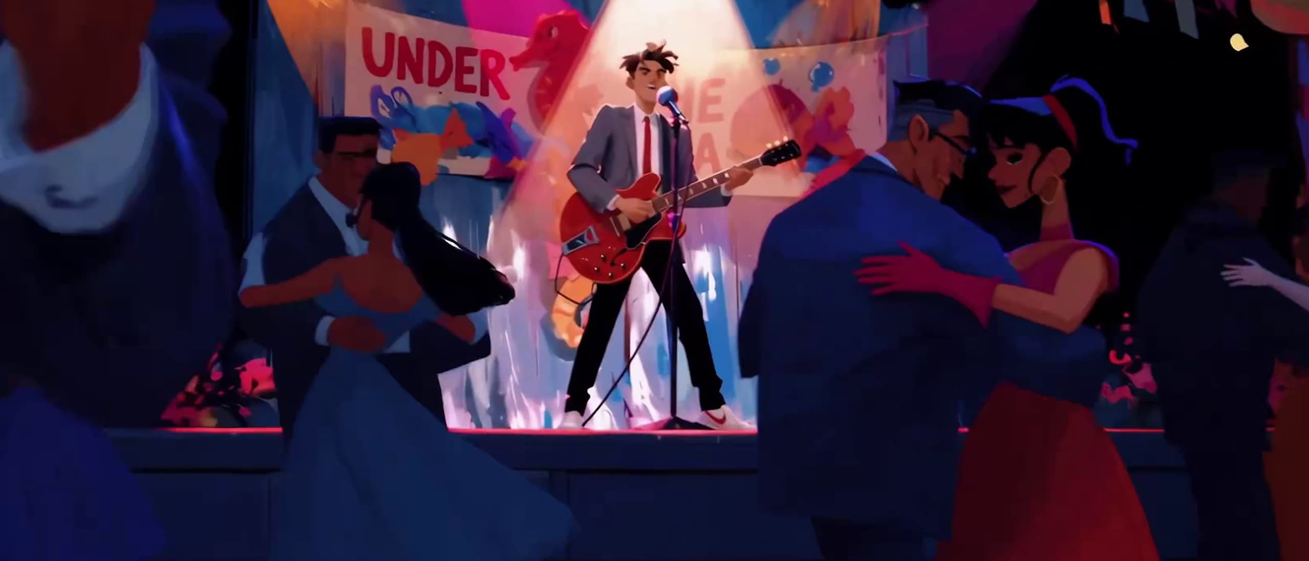 Animated comic-style frame of Marty McFly playing a red guitar in a spotlight on a school dance stage under an Under the Sea banner, with couples dancing in the foreground